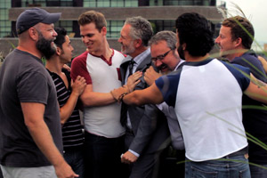Film Still BEARCITY 2: THE PROPOSAL by director Doug Langway; a group of friends (Brian Keane, Joe Conti, Stephen Guarino, Gerald McCullouch, Gregory Gunter, James Martinez, Alex Di Dio) is celebrating on the roof of a city building