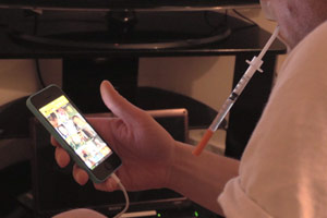 Filmstill Chemsex, Grinder-App auf Smartphone mit Nadel zum Spritzen von Drogen