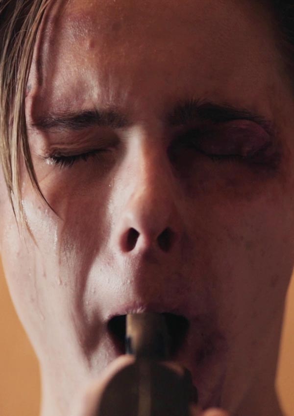 BULLY (Deutschland-Premiere) Film Still Bully von Regisseur, Autor und Komponist Aaron Alon, USA, 2018; Sam Bradley (gespielt von Edward Henrickson) hat ein Veilchen und hält sich verzweifelt den Lauf einer Pistole in den Mund